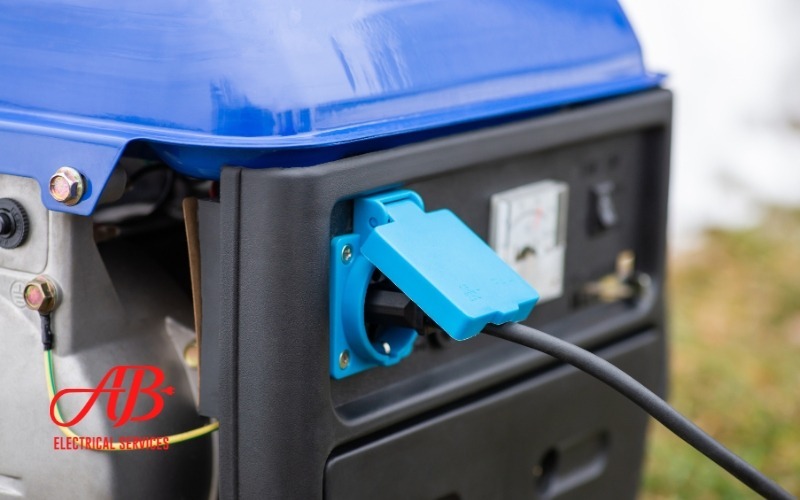 AB Electrical Services Close-up of a blue and black portable generator with a plugged-in power cord, featuring weatherproofing for reliable connection in all conditions. Orange County CA